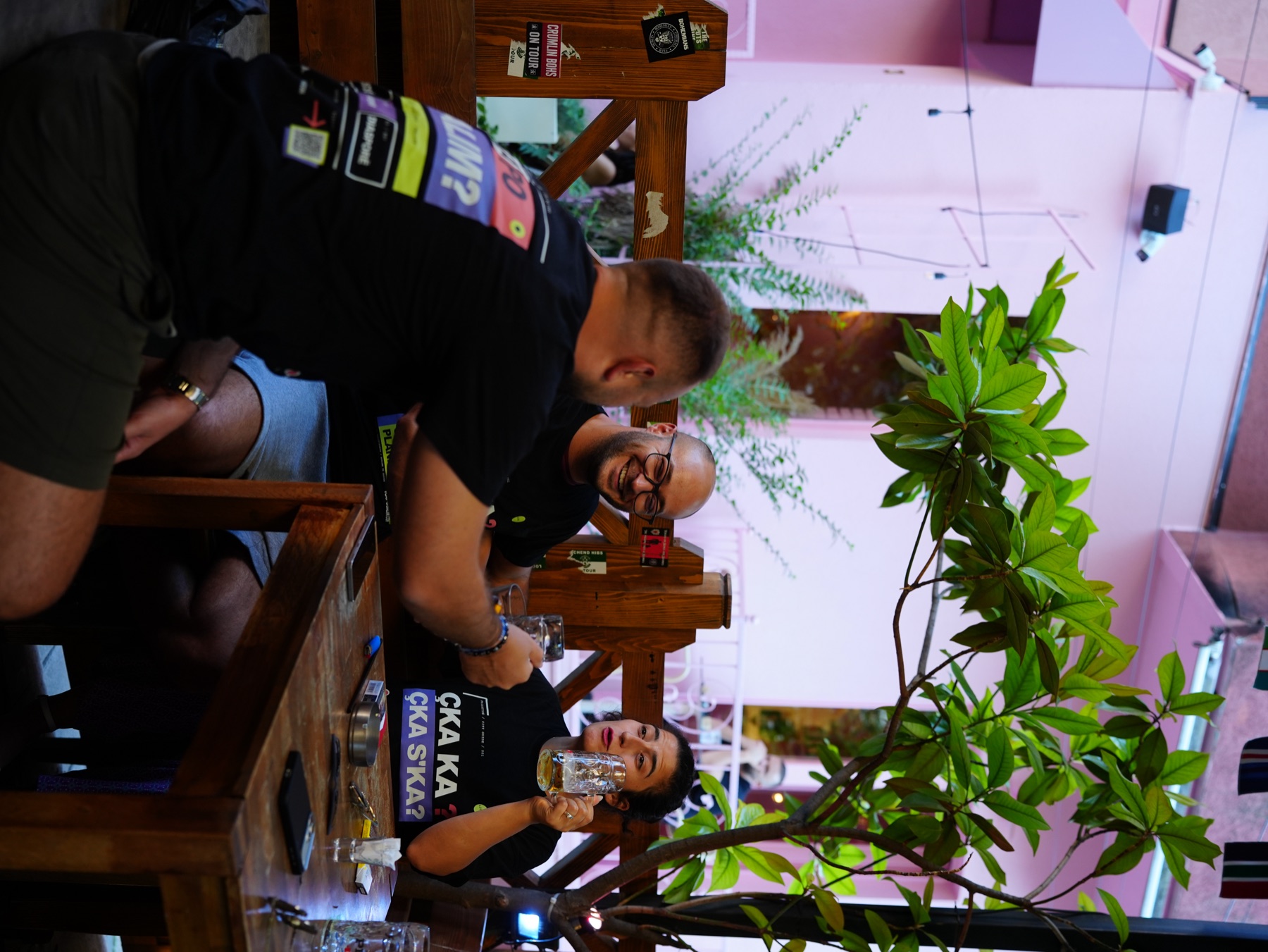 Friends around a table wearing the RRUGA 01 T-shirt