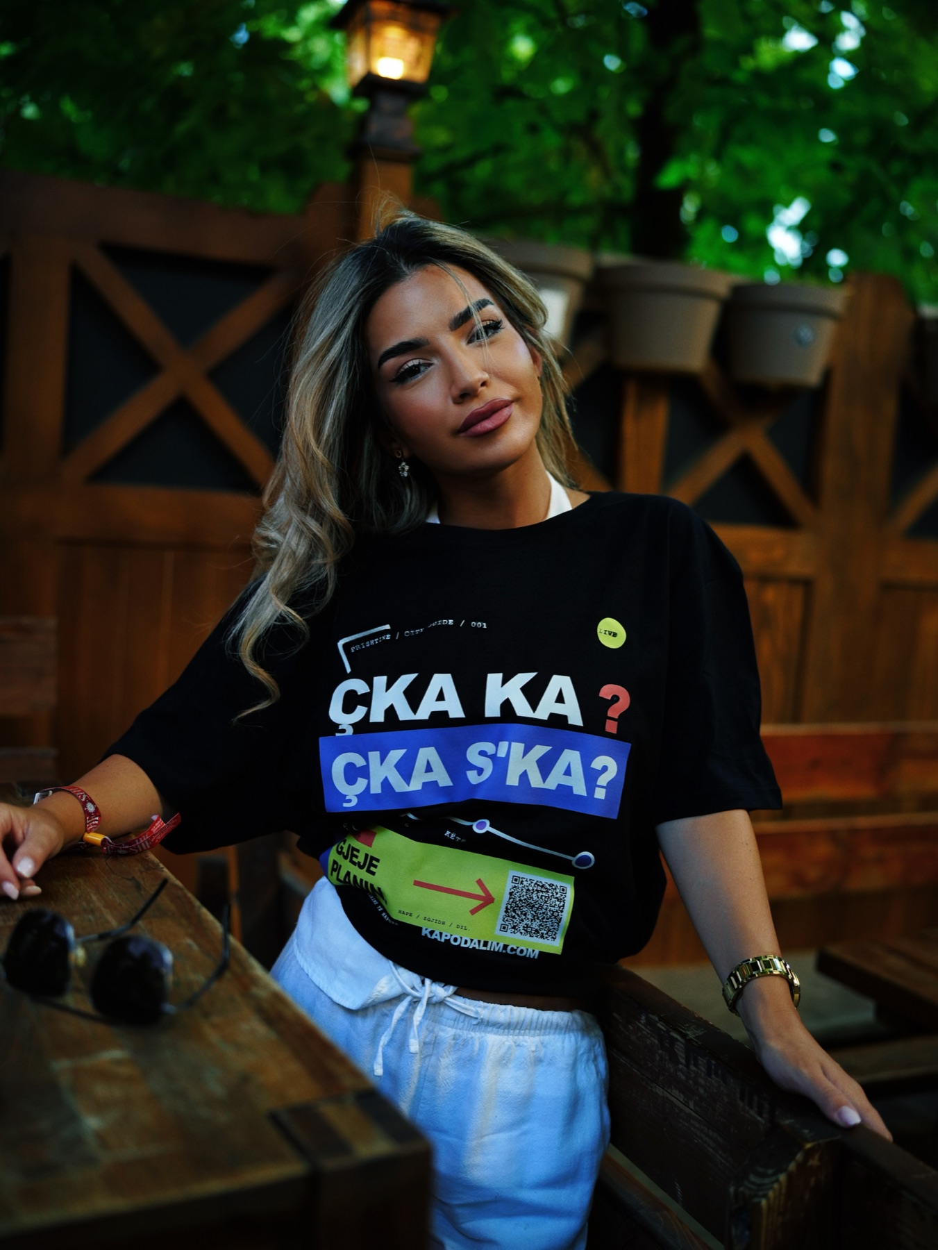 Woman wearing the RRUGA 01 T-shirt and showing its front print